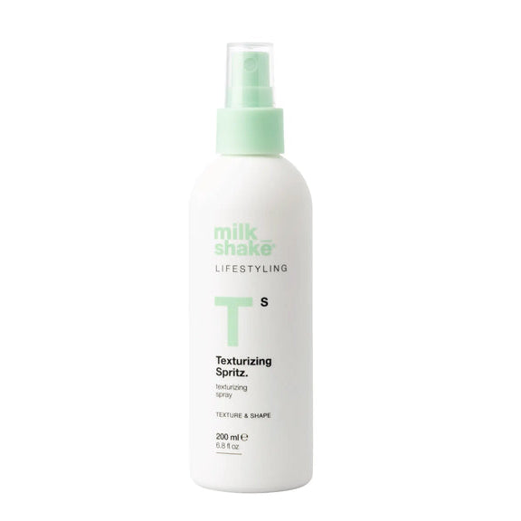 Milkshake White texturizing spritz spray bottle with green nozzle labeled 'milk_shake' on a white background