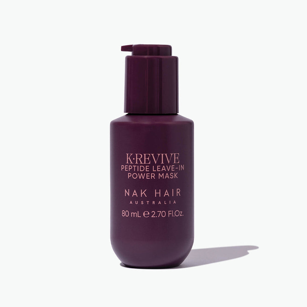 Purple bottle of K'Revive Peptide Leave-In Power Mask by Nak Hair on a white background