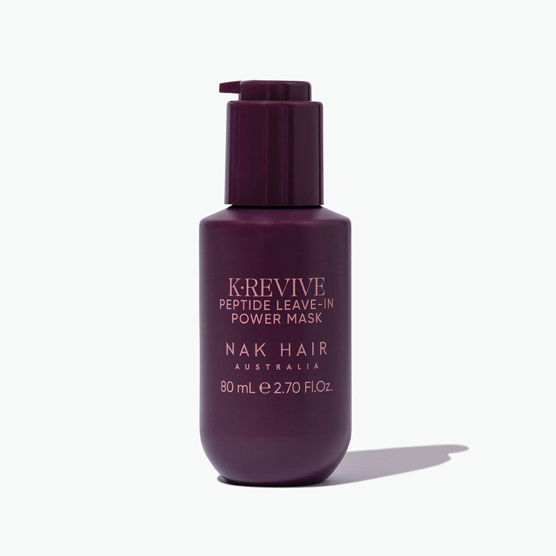 Purple bottle of K'Revive Peptide Leave-In Power Mask by Nak Hair on a white background