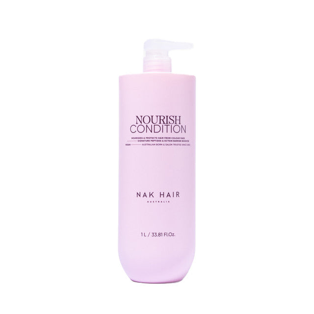 Pink bottle of NAK Hair Nourish Condition on a white background