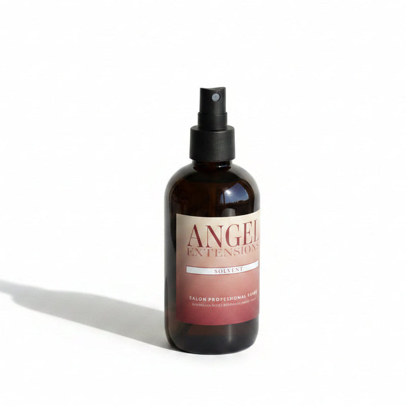 Bottle of Angel Extensions solution on a neutral background