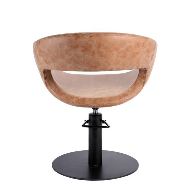 tan leather salon chair with a black base on a white background