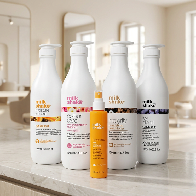 Milkshake shampoo, conditioners and Incredible Milk leave-in treatment on a salon counter with a softly blurred background
