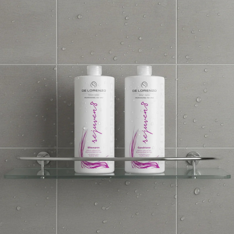 Two bottles of De Lorenzo Rejuven8 shampoo and conditioner on a shower shelf 