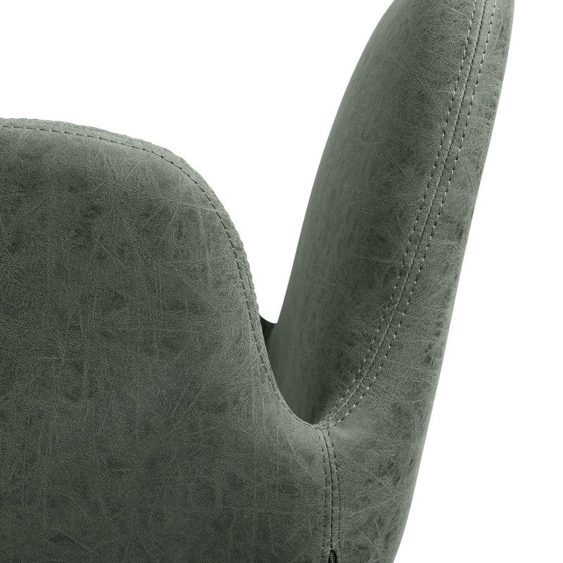 Close-up of a textured sage green upholstered salon chair back and armrest against a white background.