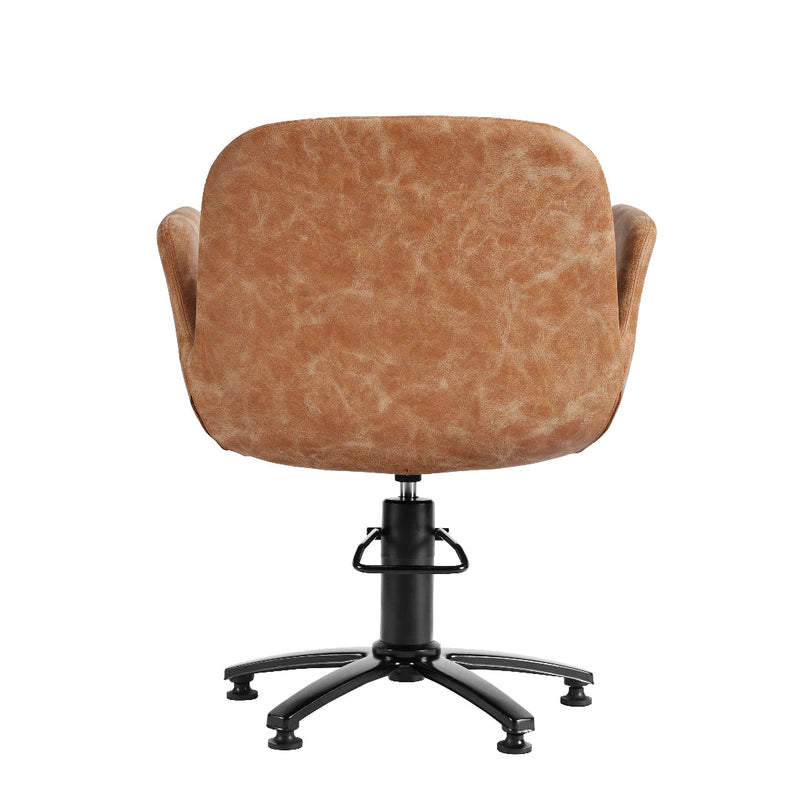 A modern swivel salon hairdressers chair with a rounded, cushioned backrest upholstered in a textured tan leather or faux leather material, supported by a black five-star swivel base.