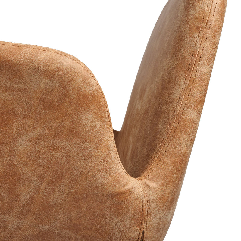 Close-up of a curved upholstered salon chair back in a warm tan or camel suede-like fabric against a plain white background.